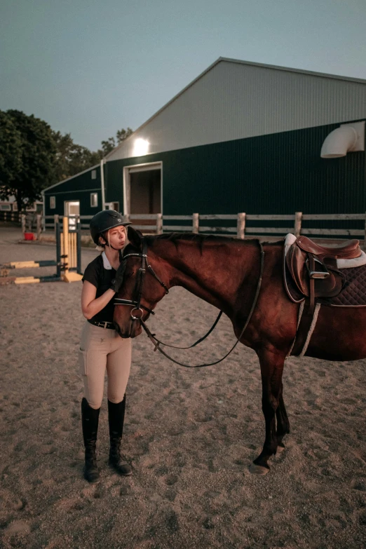 a woman is standing with a horse in the dirt