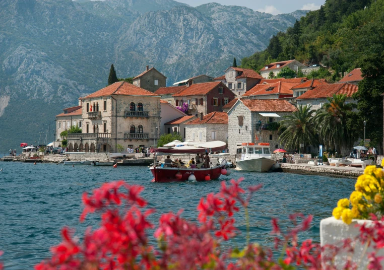 a beautiful view of some boats in the water and mountain range