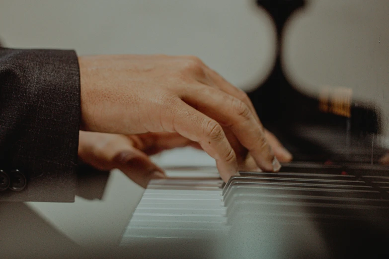 a man is playing piano in a room