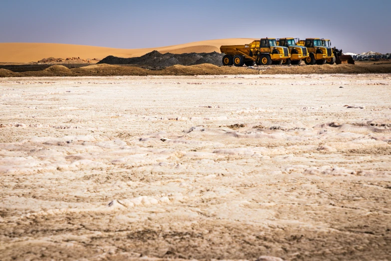 a large bus is sitting in the desert