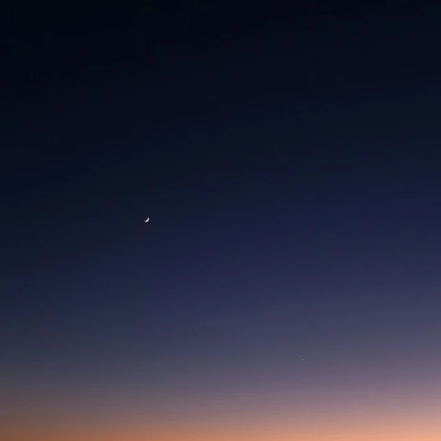 an airplane is flying through the sky during the sunset