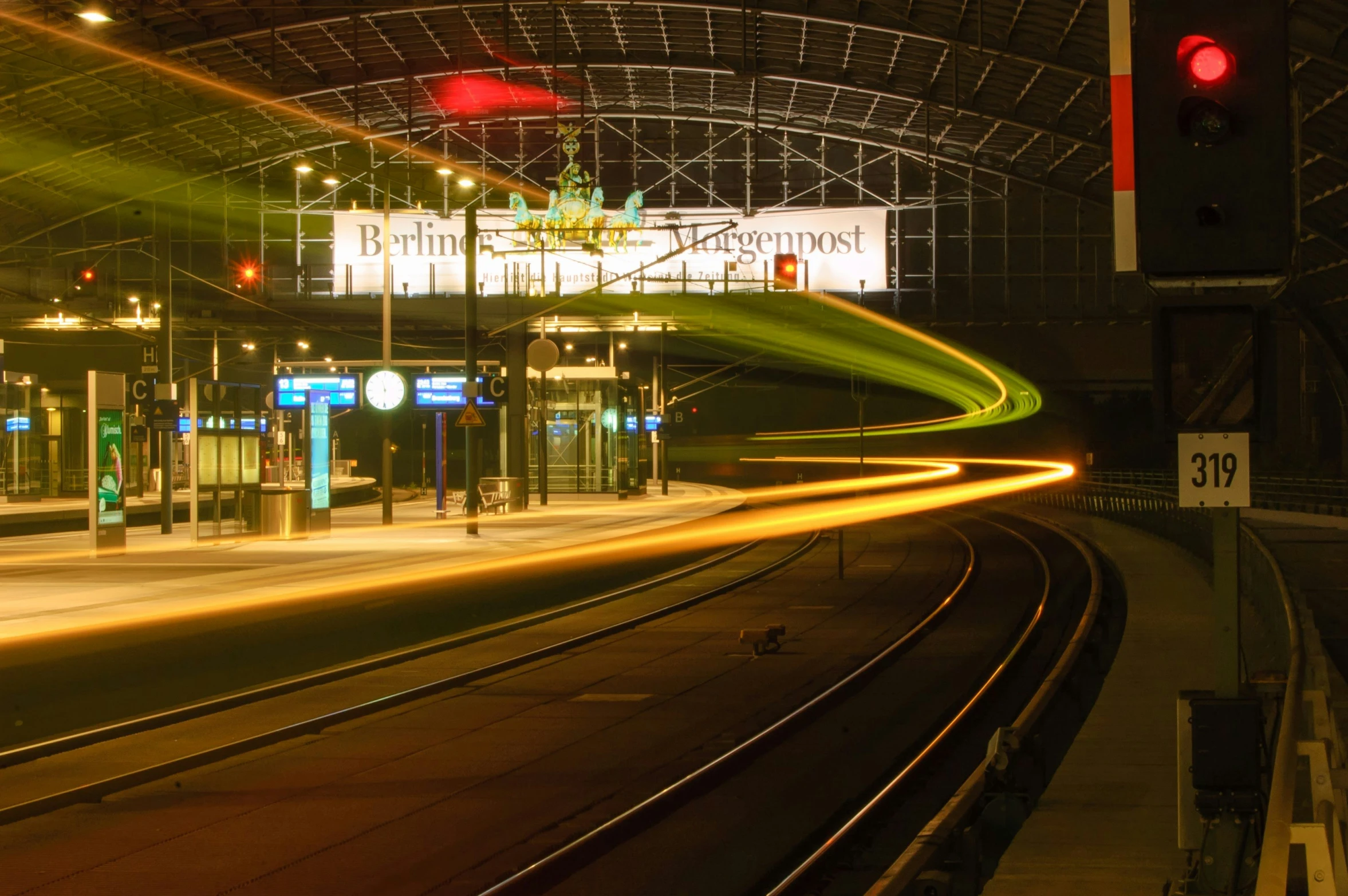 a train station with a street and stoplight