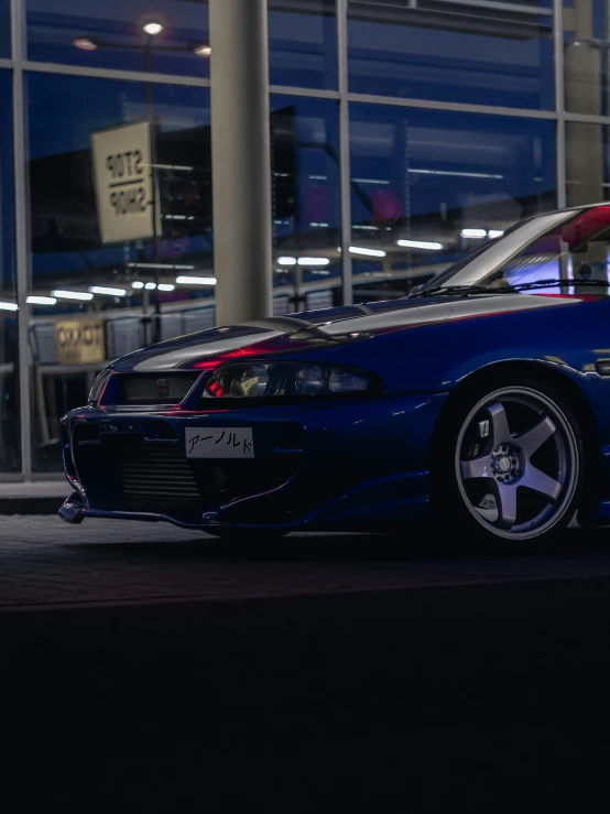 a small sports car on the street at night