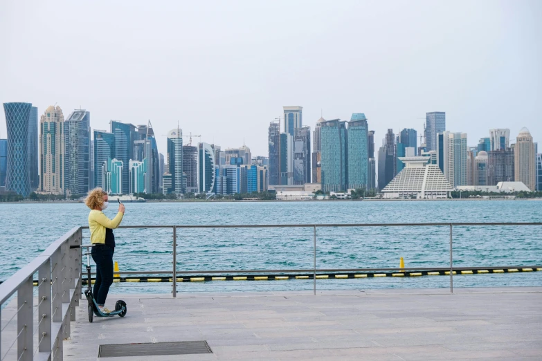 a woman is looking at a large city skyline