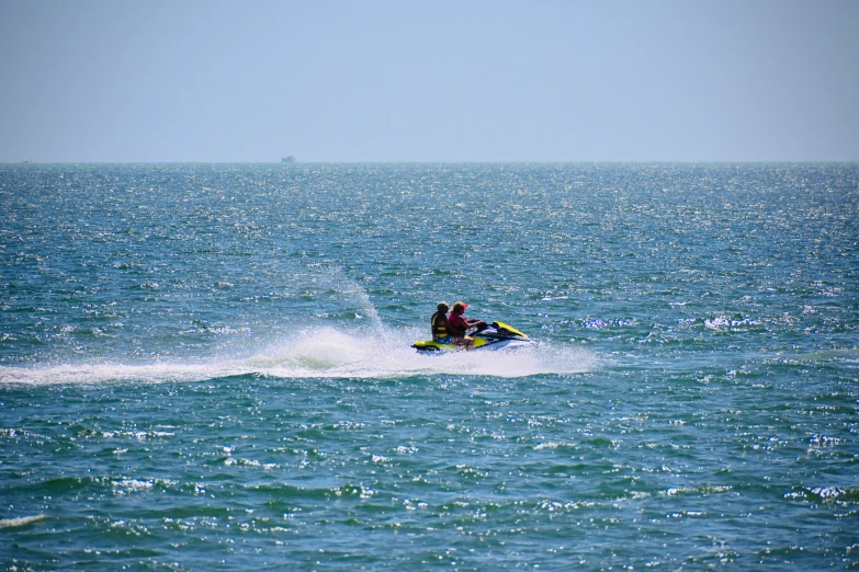 a person riding on a jet ski in the middle of the ocean