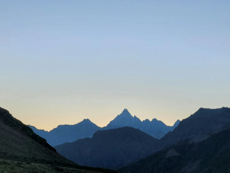 mountains are seen in the distance at sunset