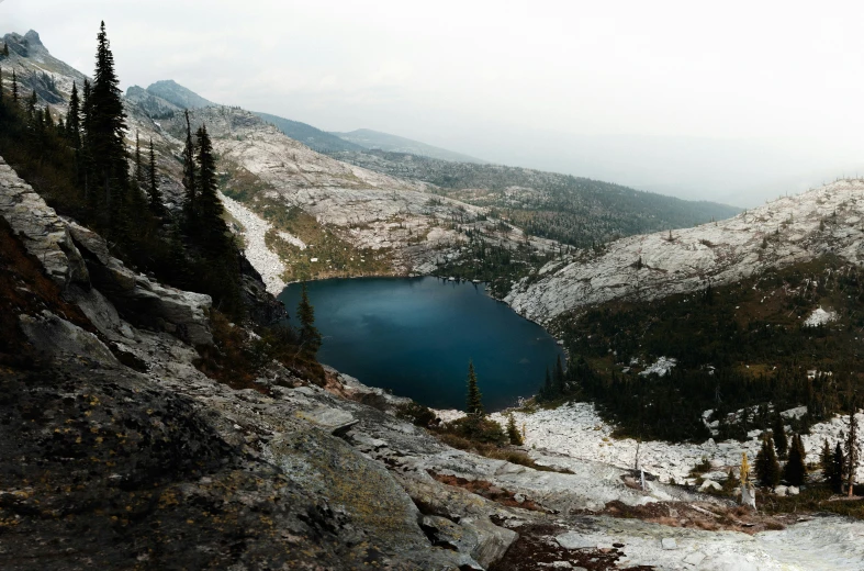 the blue lake is hidden behind large rocks