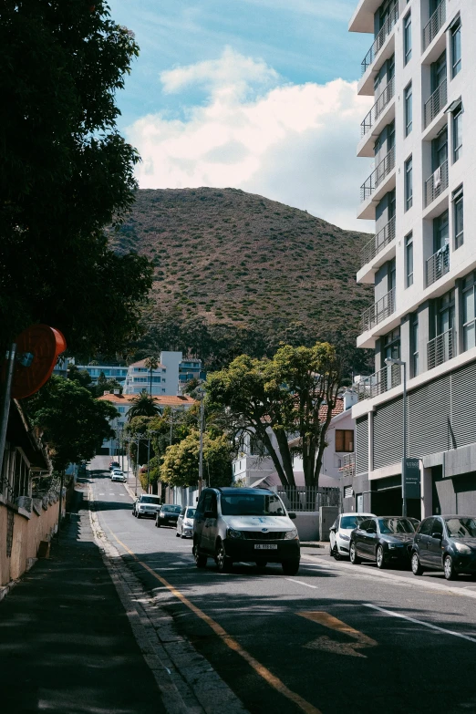 a city street with cars parked along both sides