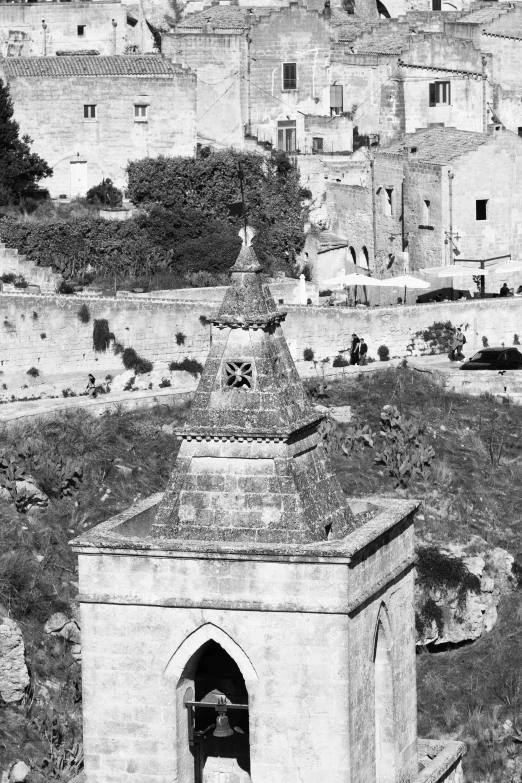 a bell tower sitting in the middle of a field