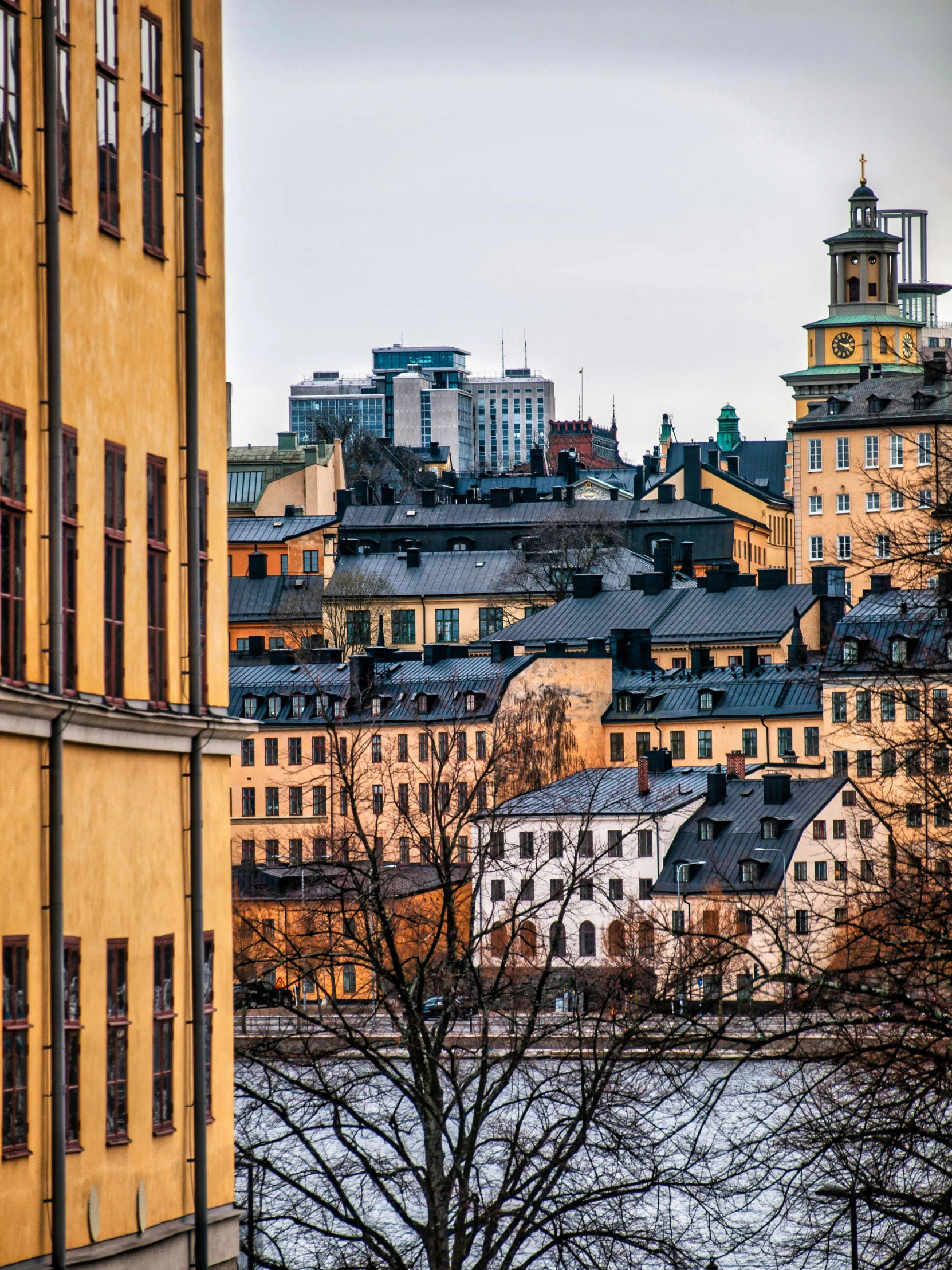 the top of a yellow building with lots of windows