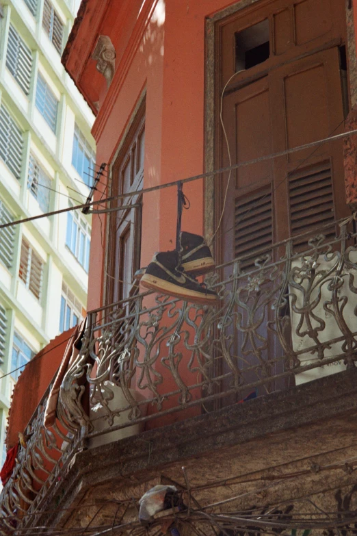 a balcony with a metal railing and an iron fence