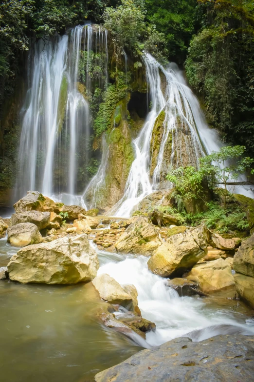 a waterfall with large rocks on top of it