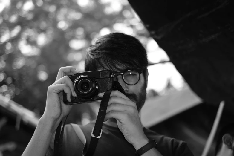 black and white pograph of man using camera for pos