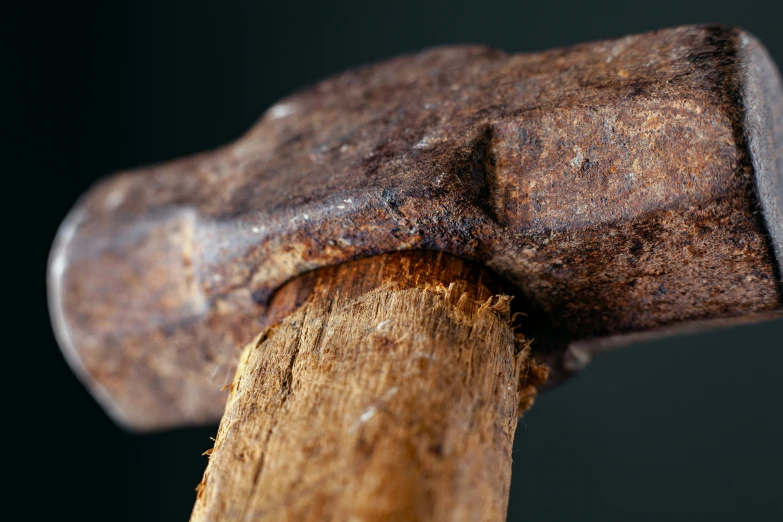 a hammer is stuck into a piece of wood