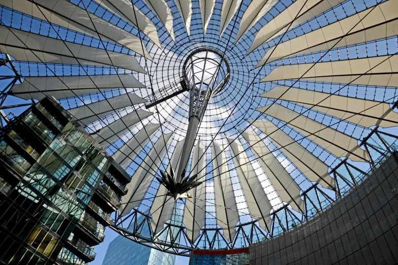 the ceiling of a large building with glass windows