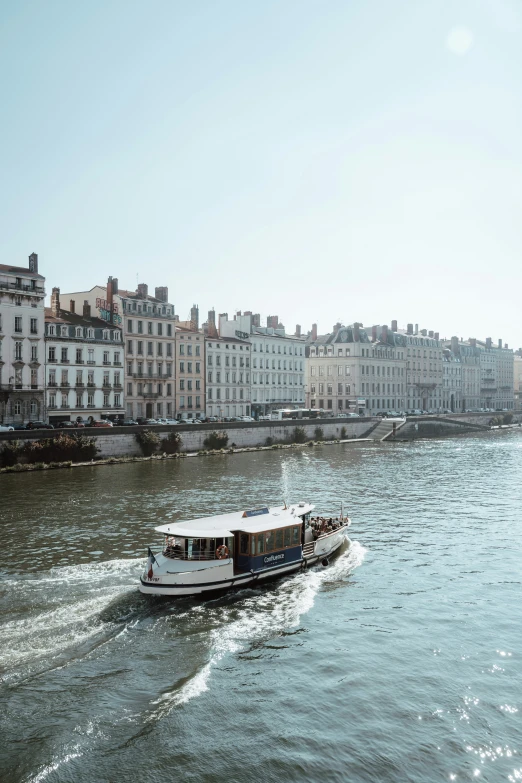 boats on the water near some buildings in a river