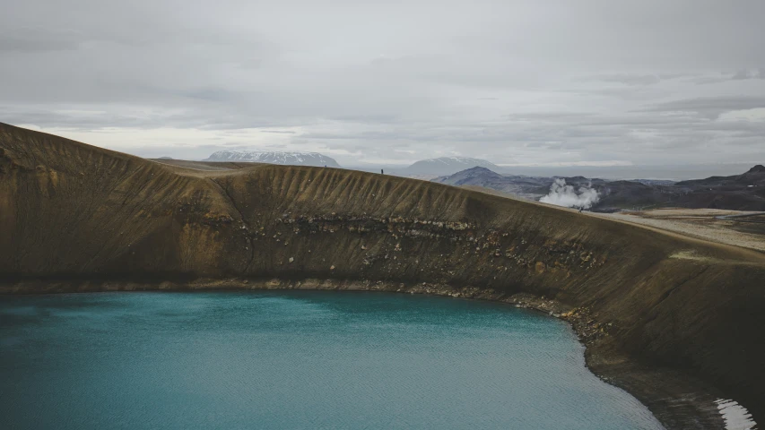 a blue body of water sitting on top of a mountain