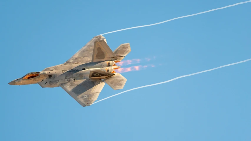 an air force jet flies through the sky