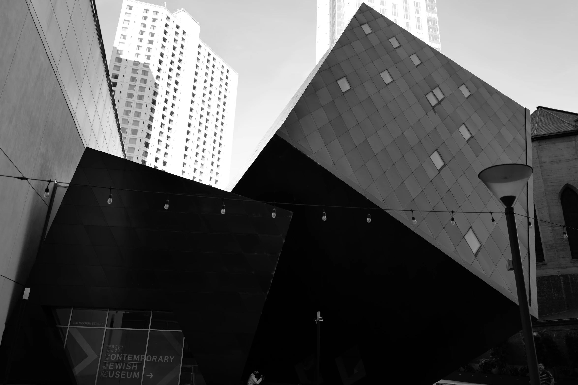 two buildings sit side by side against a blue sky