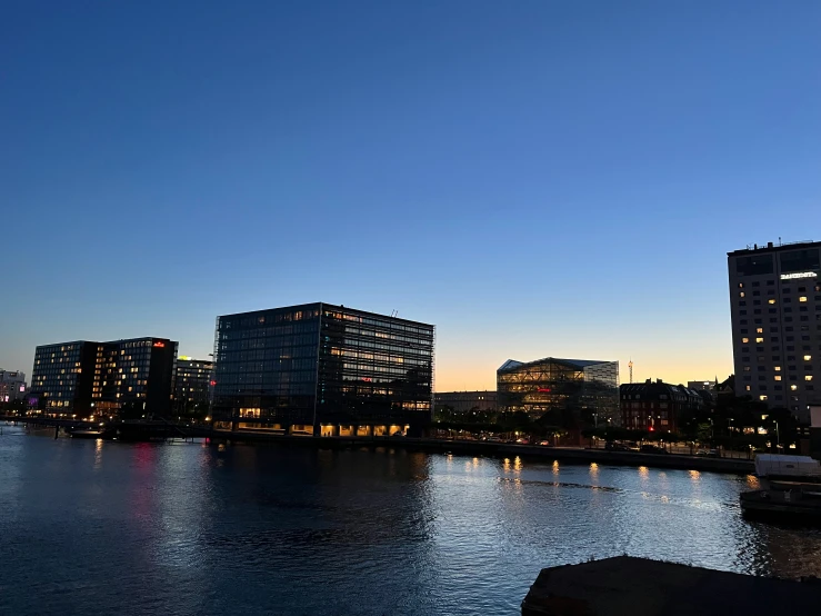 two boats on the river in front of some city buildings