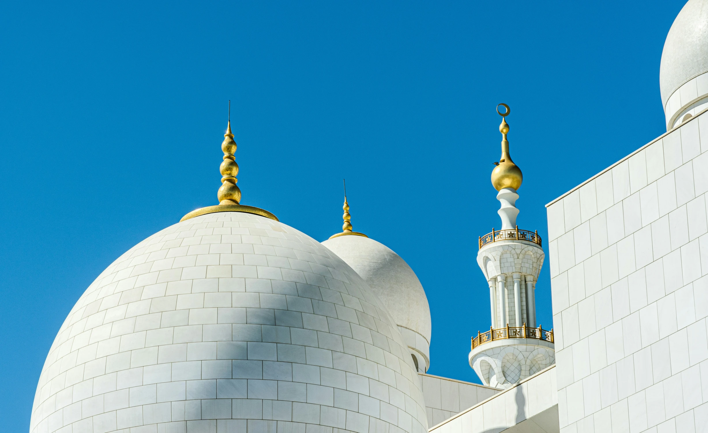 the top of a mosque has two gold crosses on it