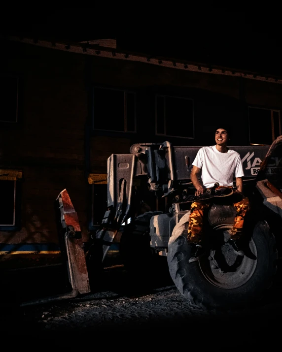 man standing on front of trailer with wheels and large tire