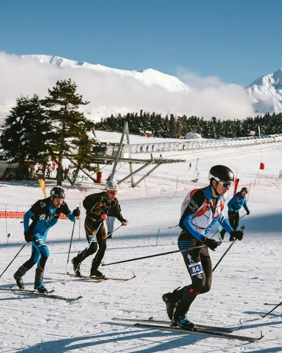 a group of people riding skis on top of a snow covered slope