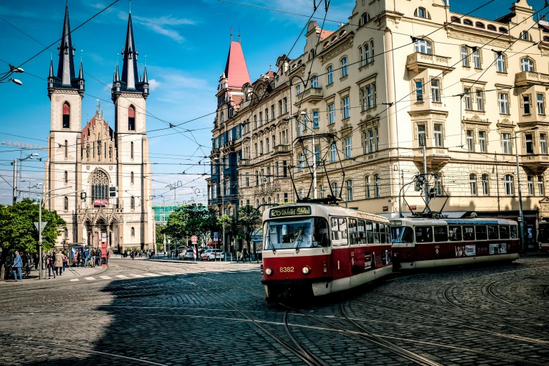 a street scene with a red trolley on the road