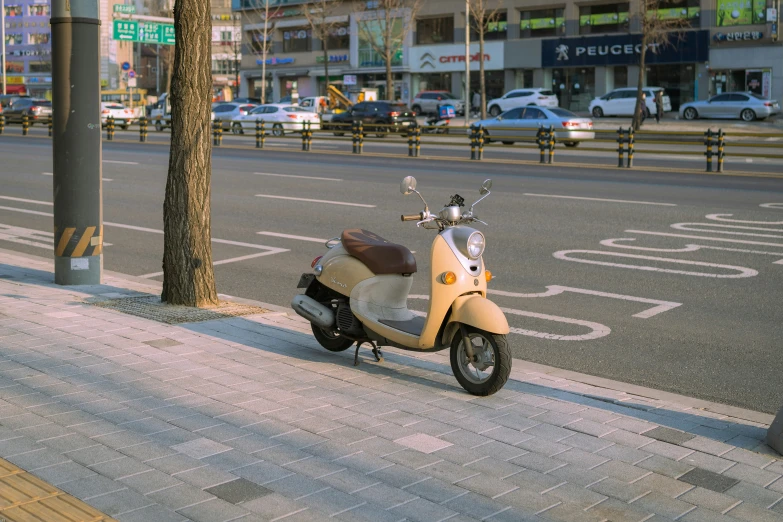 a scooter parked on the side of a road next to a street