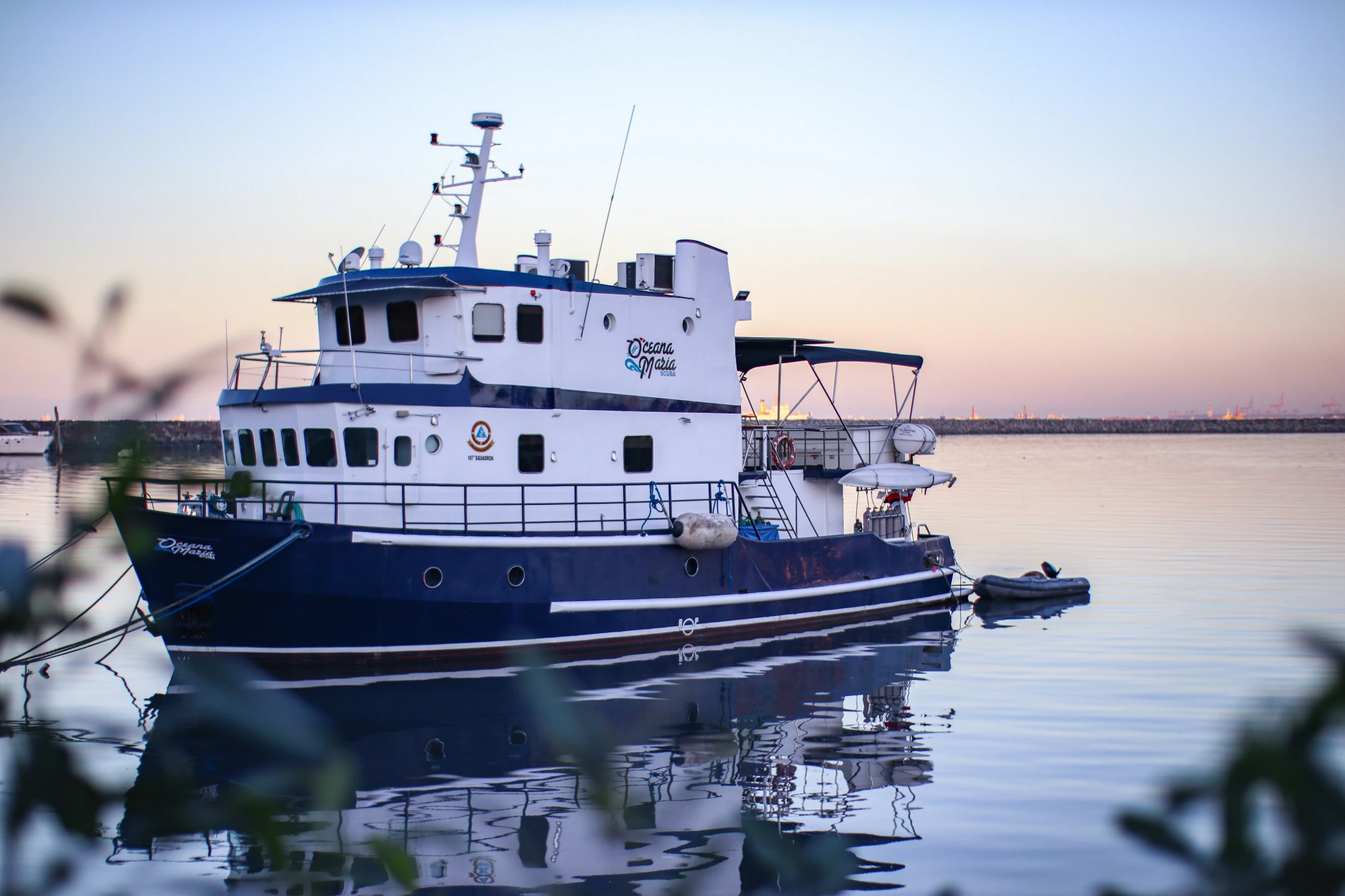 the large white and blue boat is in the water