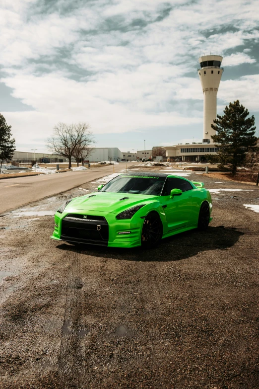 a green sports car parked in a parking lot