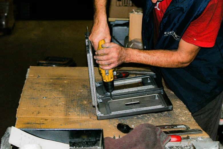 a man is making a project on top of a table