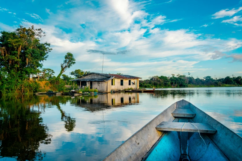 a boat is in the water with house in background