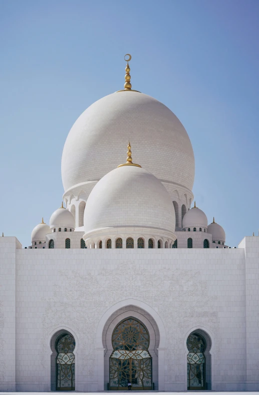 a large white mosque with arches and windows