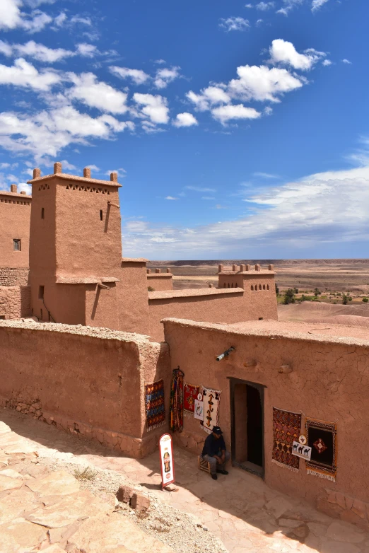 a person is walking up and down a hill with some buildings