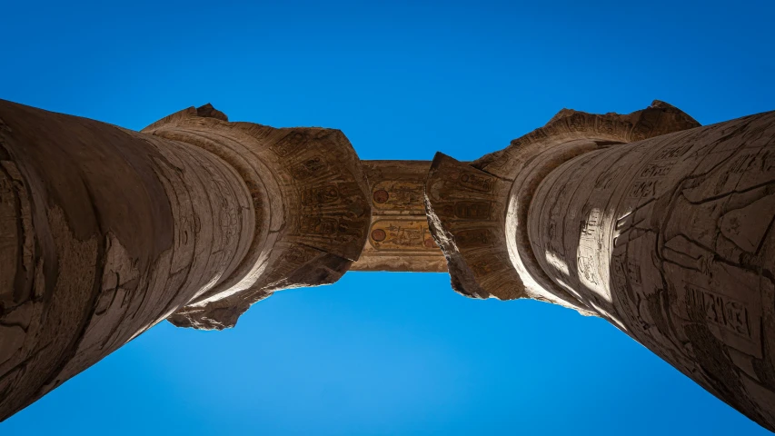 looking up at an arch of a stone building