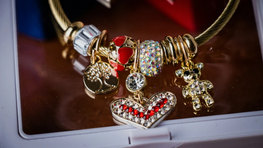 a group of gold jewelry items are on display