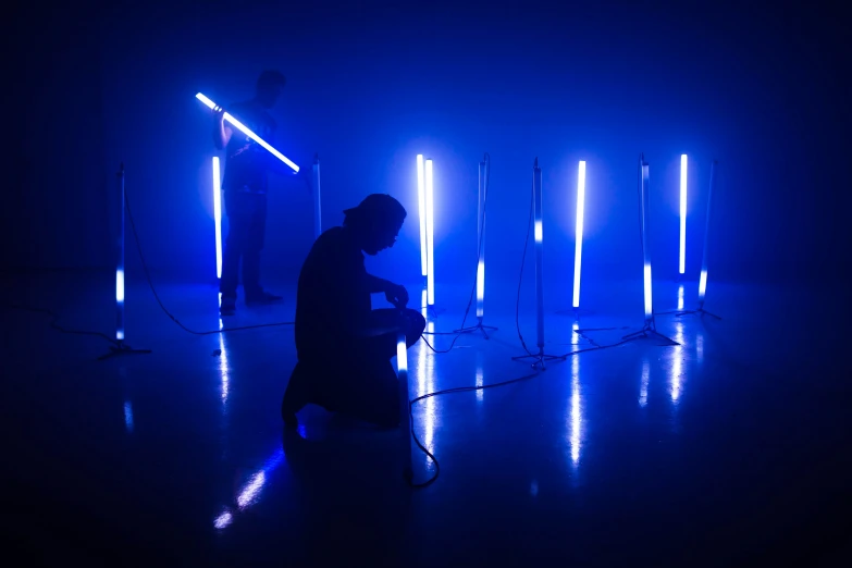 a man is kneeling down in a dark room