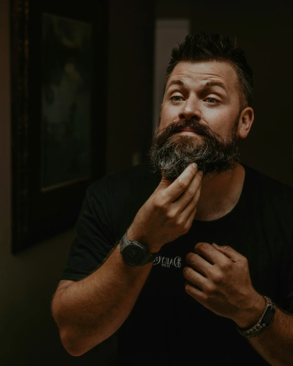 a man is shaving his beard with a watch