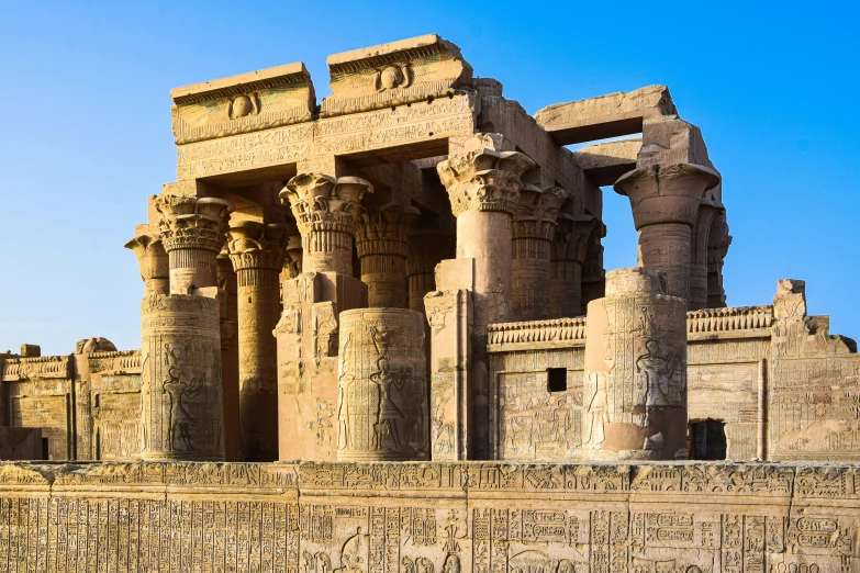 a stone and stucco structure with carvings around it