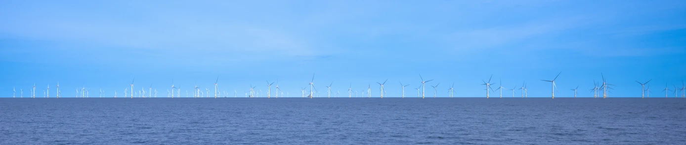 an image of wind mills on the water