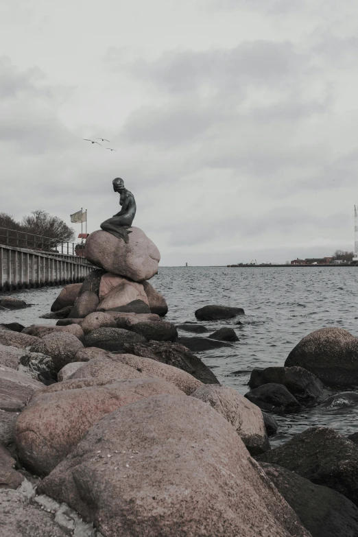 a statue that is sitting on top of a rock