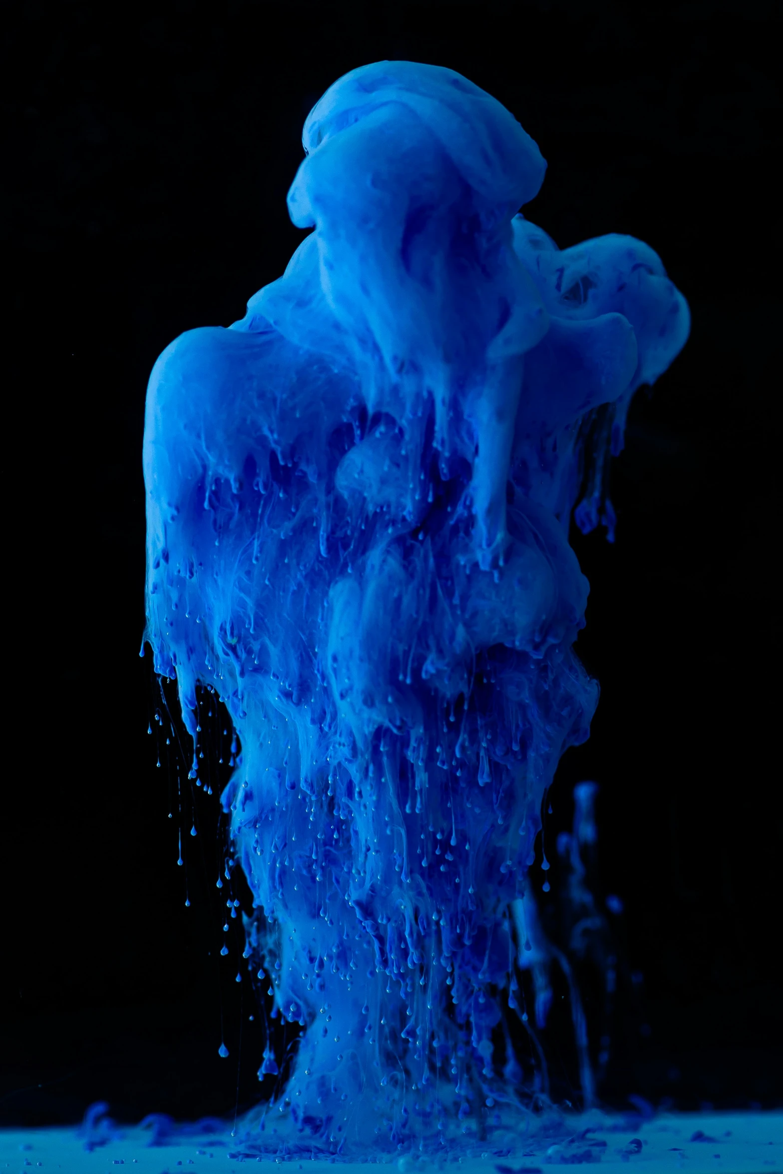 an ocean blue substance is spewing up into the water