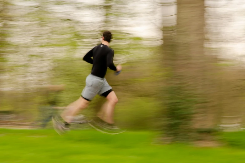 a man jogging in the park wearing shorts