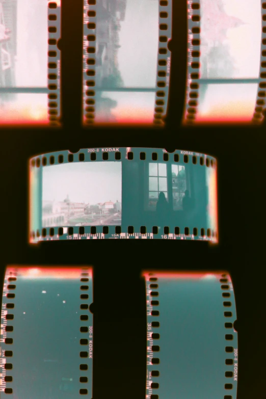 some film is lined up and on a black surface
