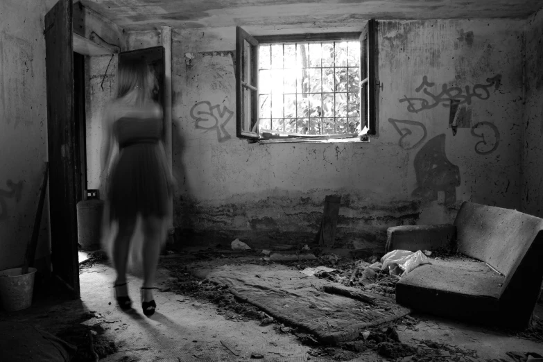 a woman is walking in an old house