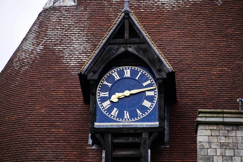 a big blue clock is on the side of a building