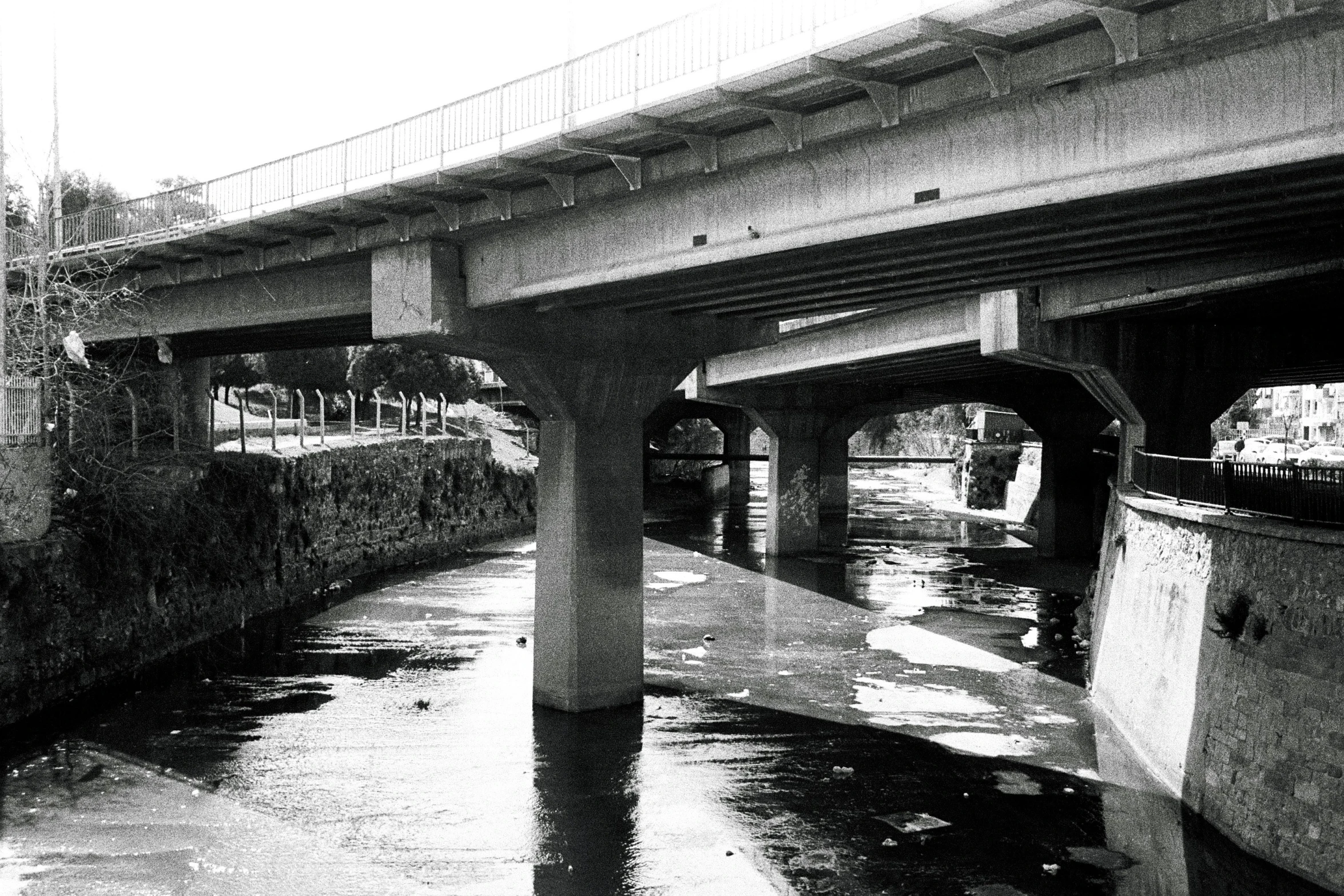 the view from underneath the bridge looking at some water