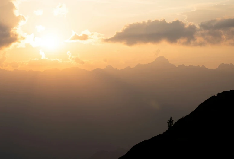 a mountain ridge with an airplane in the background