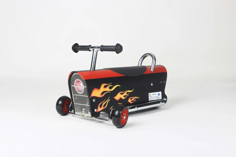 a red and black toy truck with wheels and handlebars